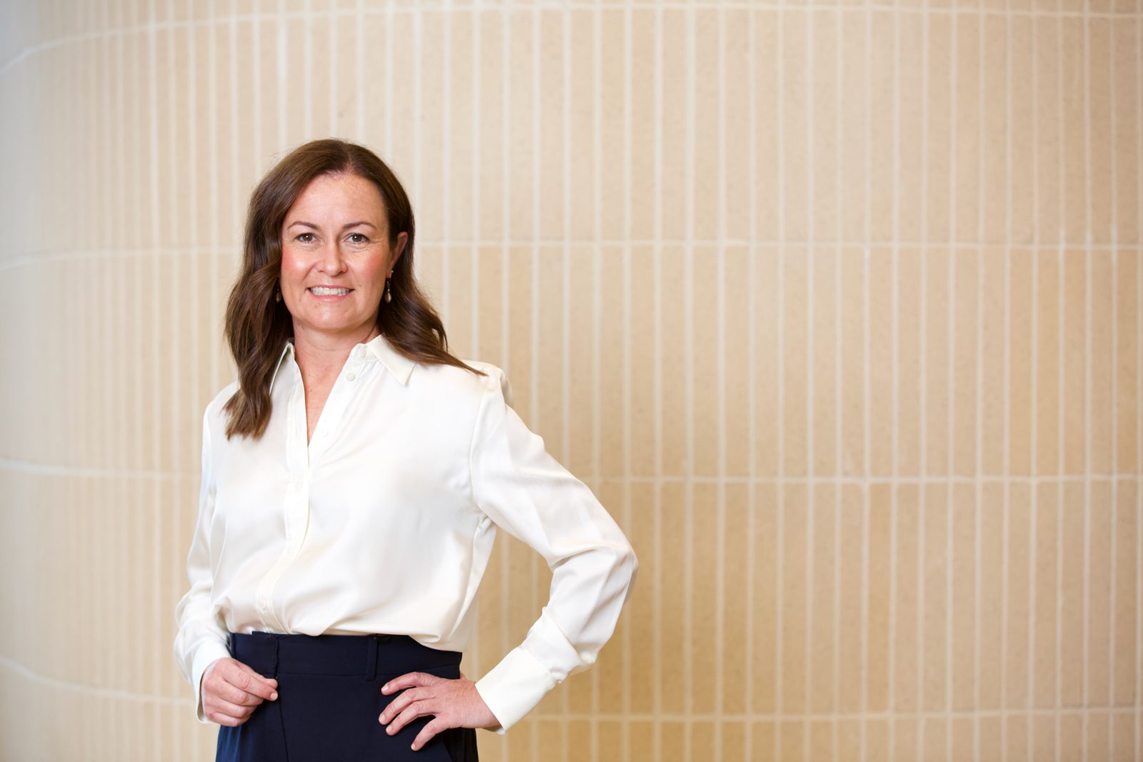 Katherine Adcock of Elevate Impact Advisory, in a quiet architectural space &mdash; Photograph by Mira Soulio